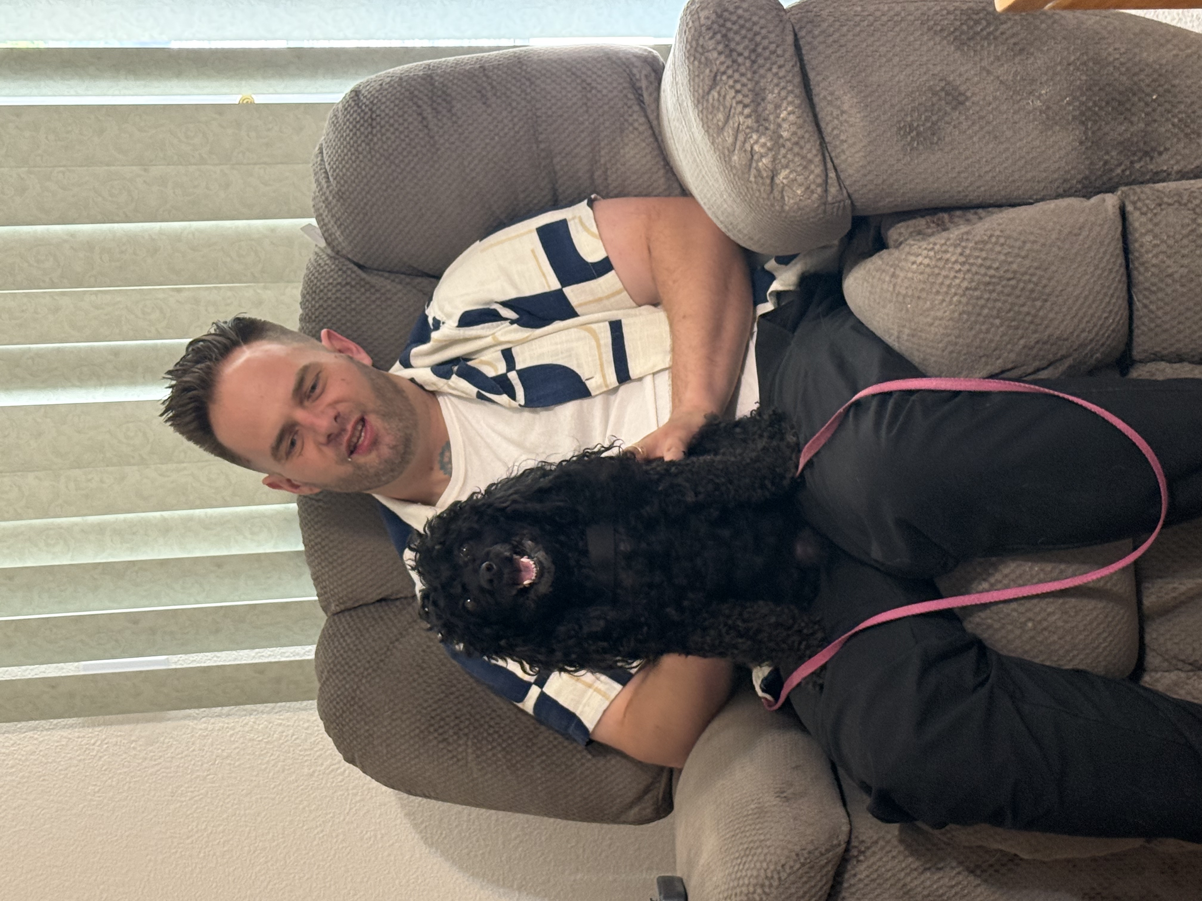 Chris Taylor relaxing with a happy poodle during an estate sale in Kingman, Arizona